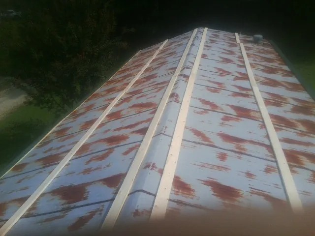 Rusted metal roof panels with new wood purlins before replacement — Storm Damage Roof Repair in Harpers Ferry by Roofing Brothers