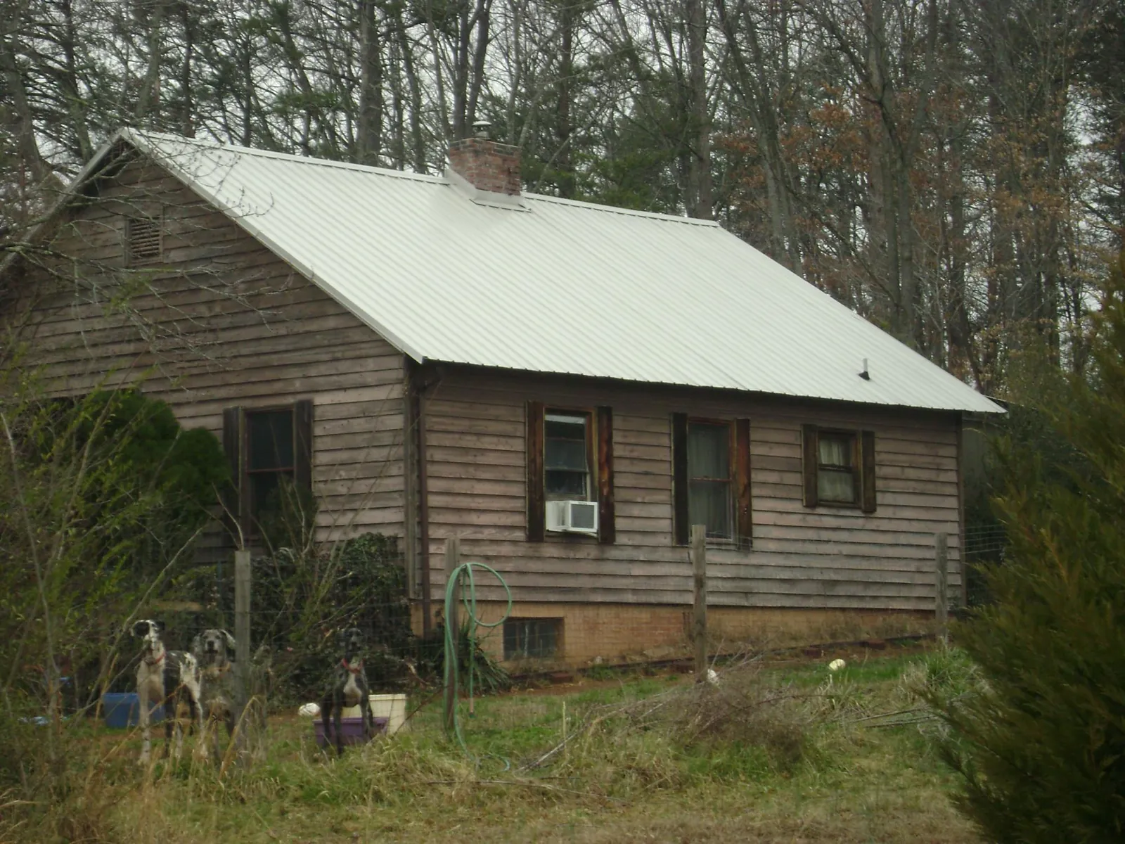 White metal roof on an old wood sided farmhouse, from a Metal Roof Installation job in Harpers Ferry